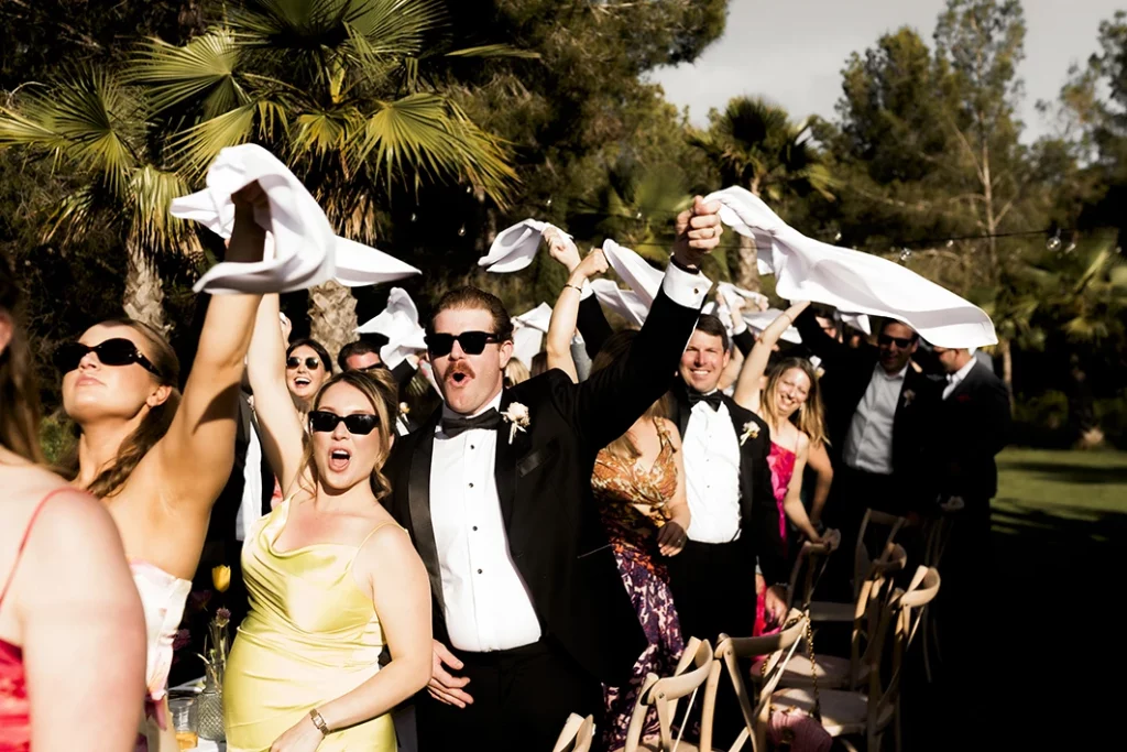 Guests celebrating with napkins in the air at a luxury wedding in Sitges.
