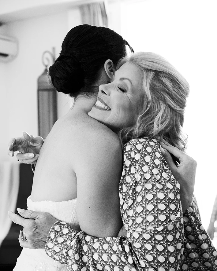 Bride and her mother sharing an emotional hug before the wedding in a luxury villa in Sitges.