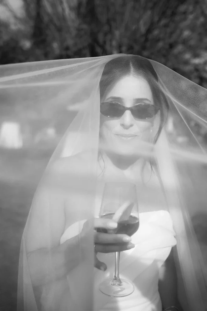 Stylish bride with sunglasses under her veil at a luxury wedding in Sitges.