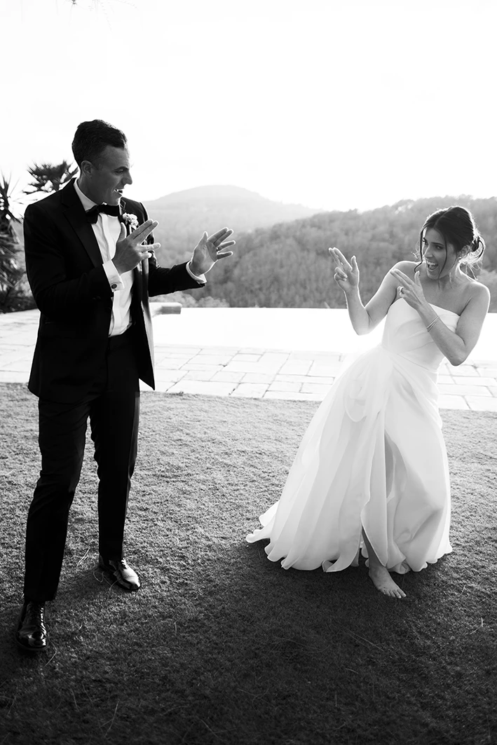 Bride and groom dancing barefoot during their wedding in Sitges.