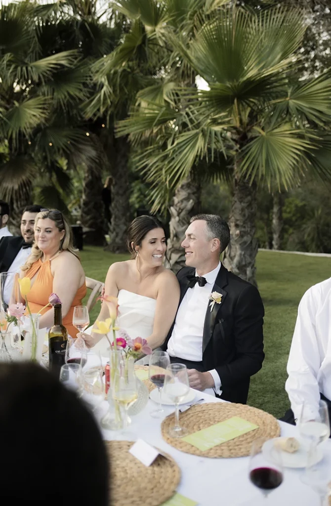 Bride Kendal and groom Matt smiling at each other during their luxury wedding in Sitges.