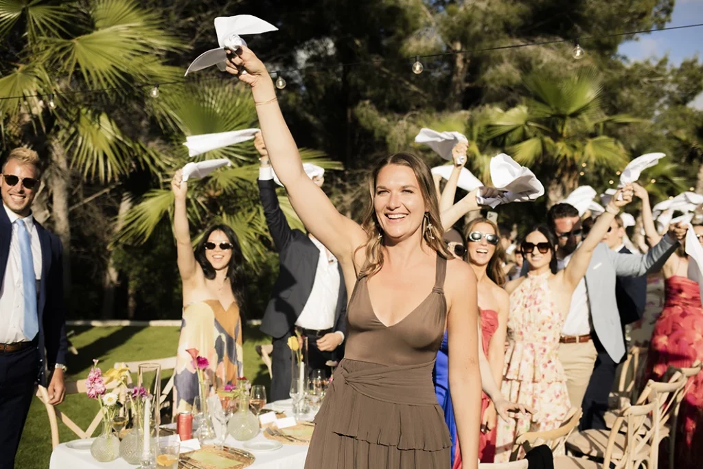 Female guest cheering at a luxury wedding in Sitges.
