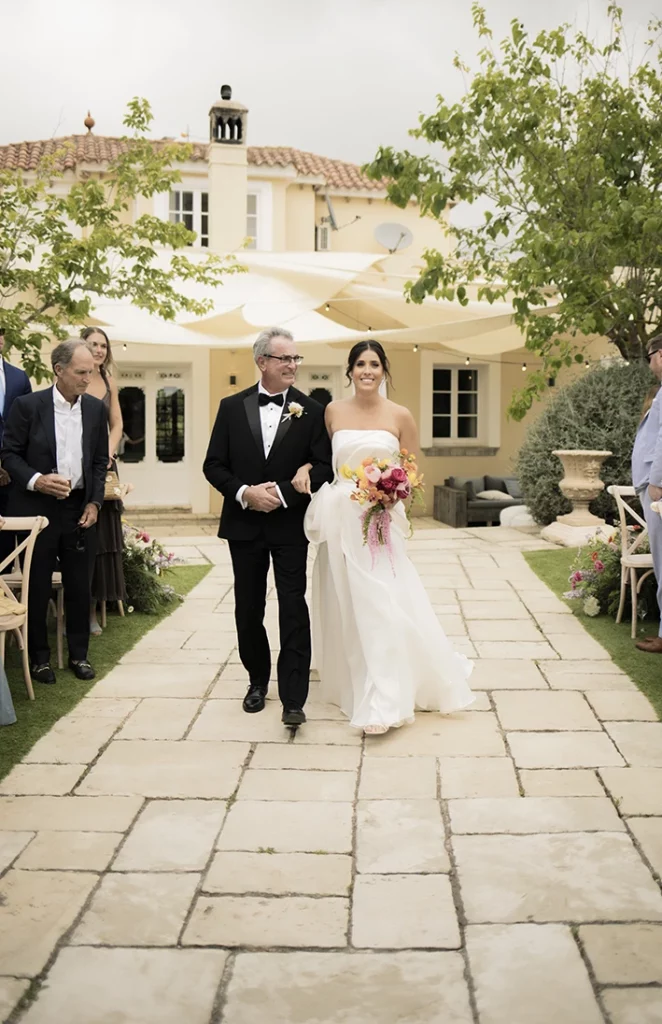 Bride walking down the aisle with her father at a luxury wedding in Sitges.