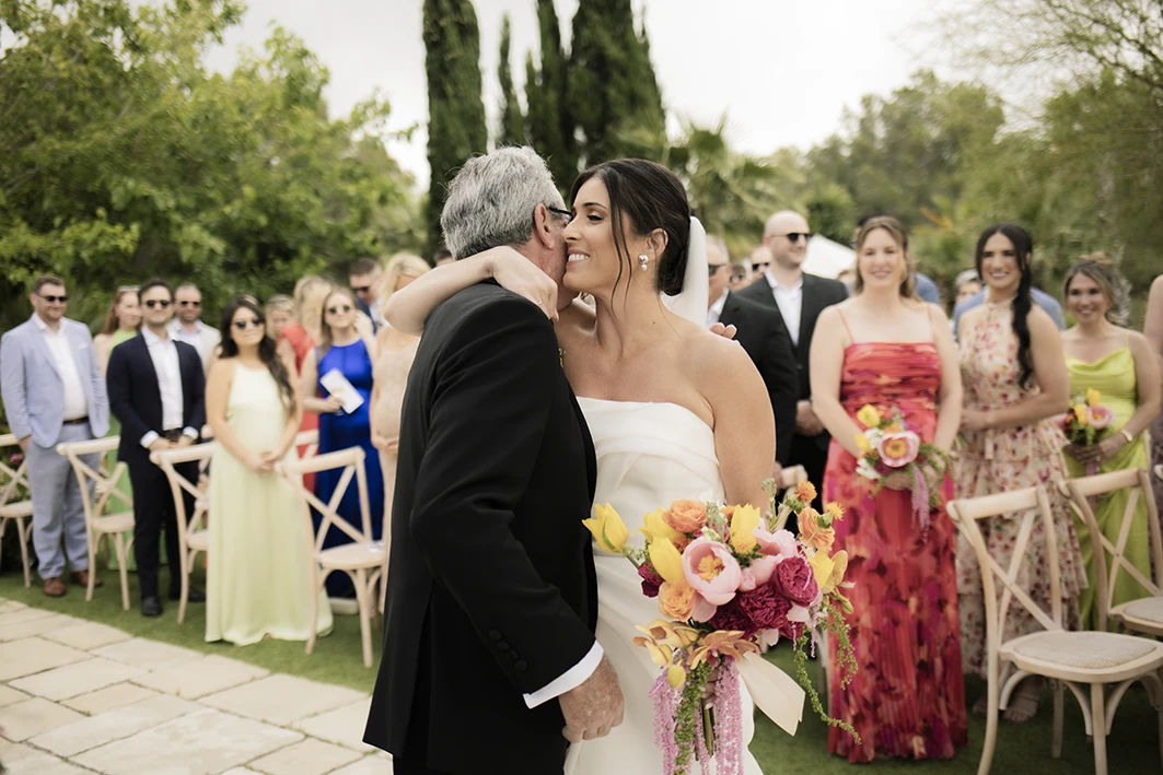 Bride embracing her father at a luxury wedding in Sitges.