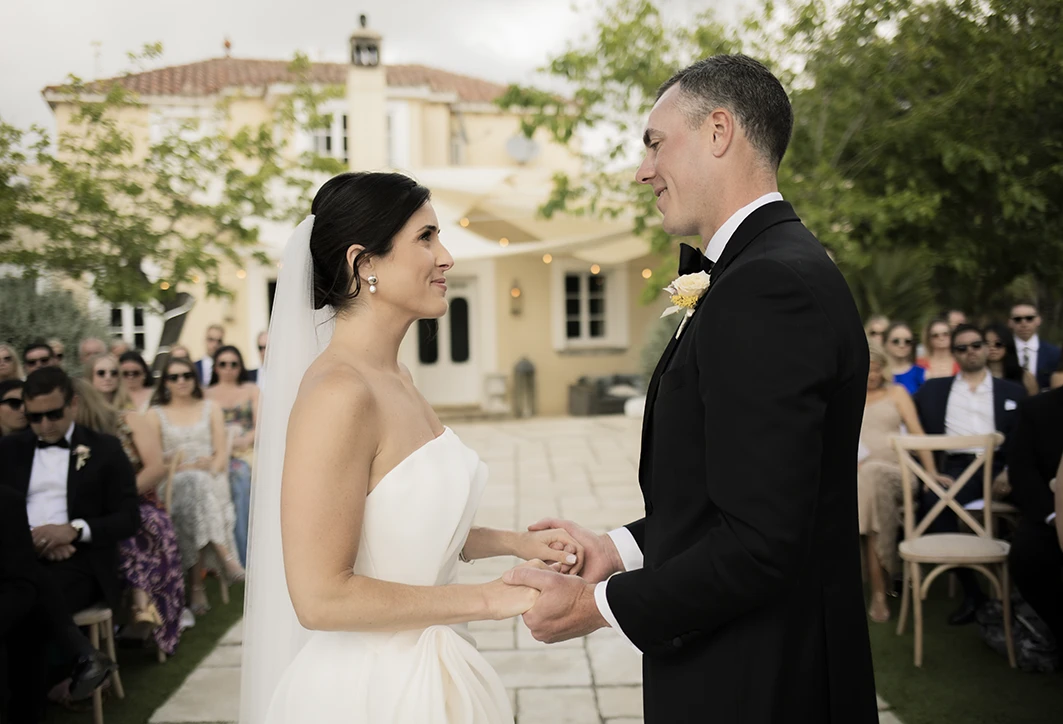 Bride and groom holding hands during their vows at a luxury wedding in Sitges.