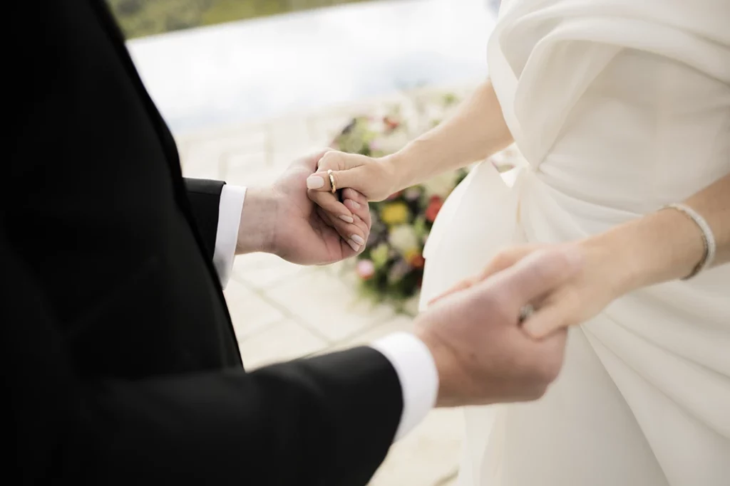Close-up of wedding ring exchange during luxury wedding in Sitges.