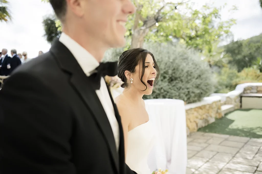 The bride laughing with joy during her luxury wedding in Sitges.