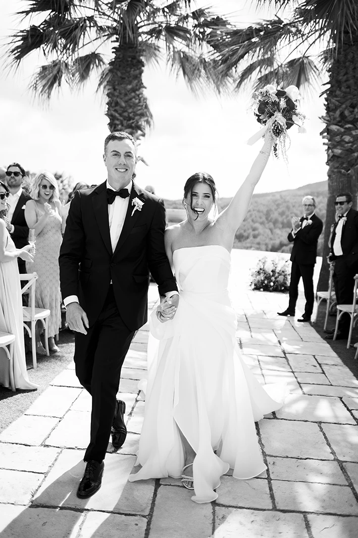 Just married couple walking down the aisle during their luxury wedding in Sitges.