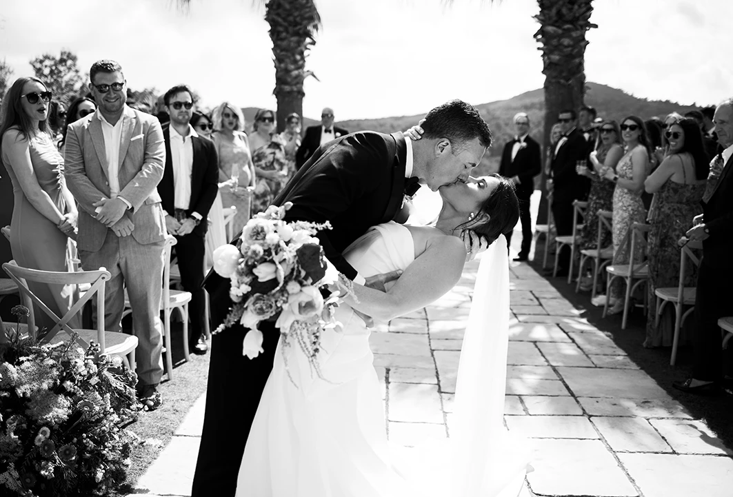Bride and groom embracing after their wedding ceremony in Sitges.