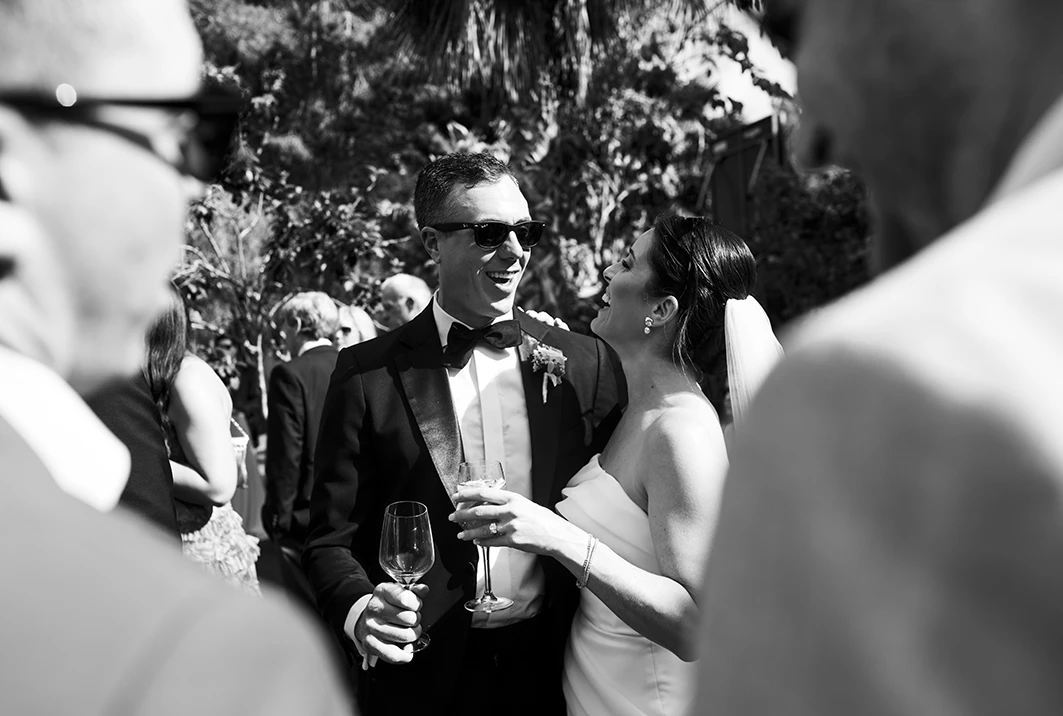 Bride and groom laughing during cocktail hour at their luxury wedding in Sitges.