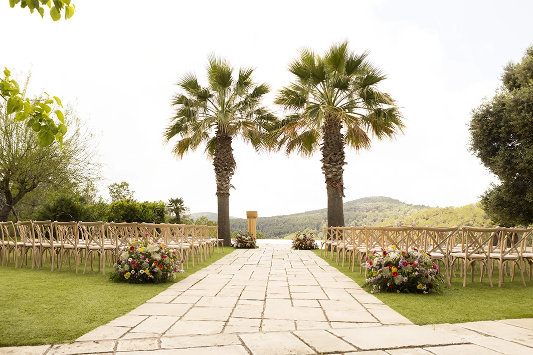 Palm tree-lined ceremony aisle at a luxury wedding venue in Sitges.
