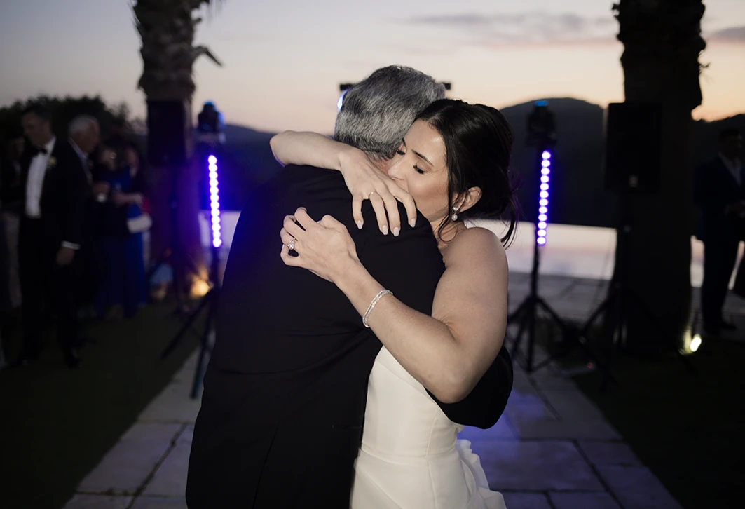 Bride embracing her father during their emotional dance at a luxury wedding in Sitges.