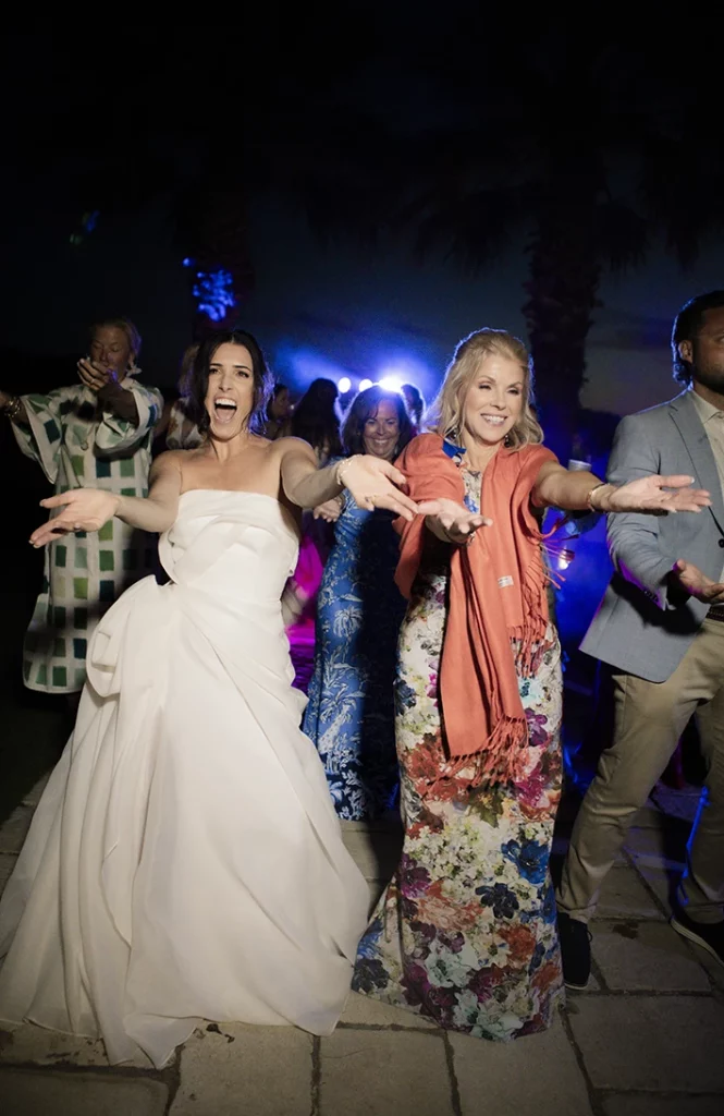 Bride dancing with friends during the lively wedding party in Sitges.