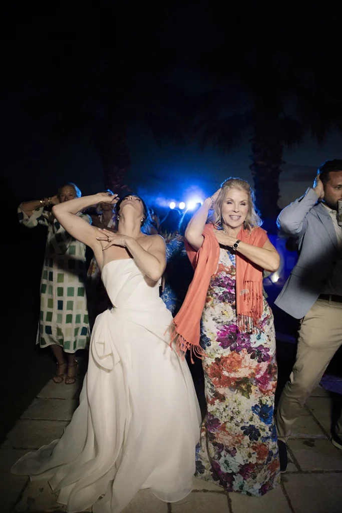 Bride dancing with friends during the lively wedding party in Sitges.