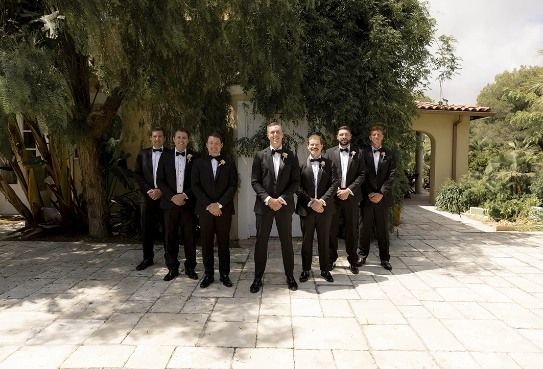 Groom with his groomsmen posing in tuxedos at a luxury wedding in Sitges.