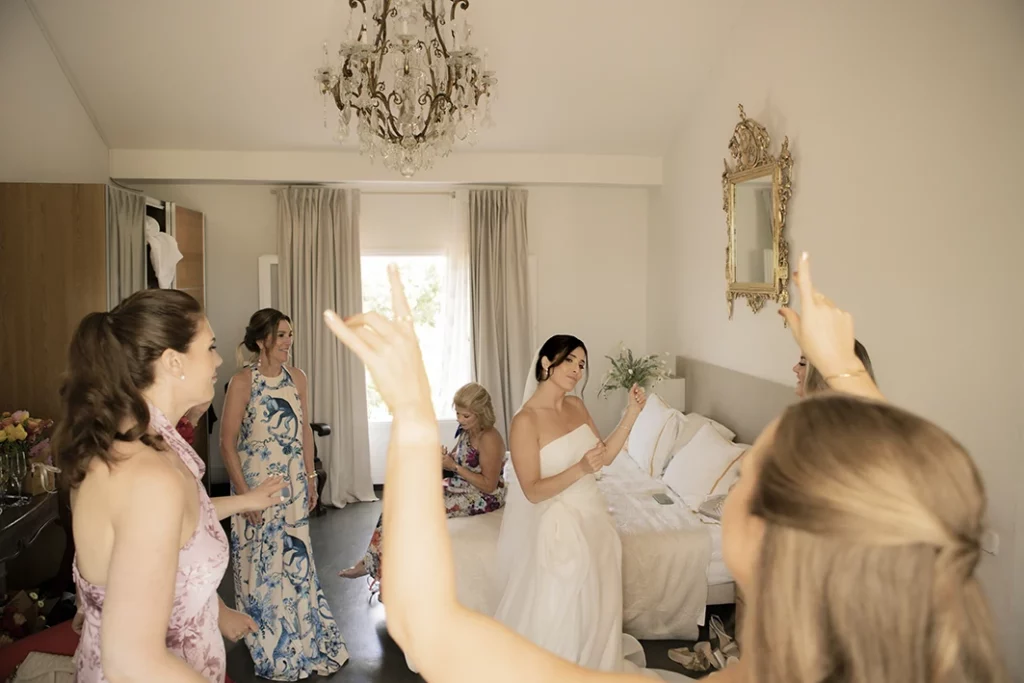 Bride celebrating with bridesmaids before the wedding in Sitges.