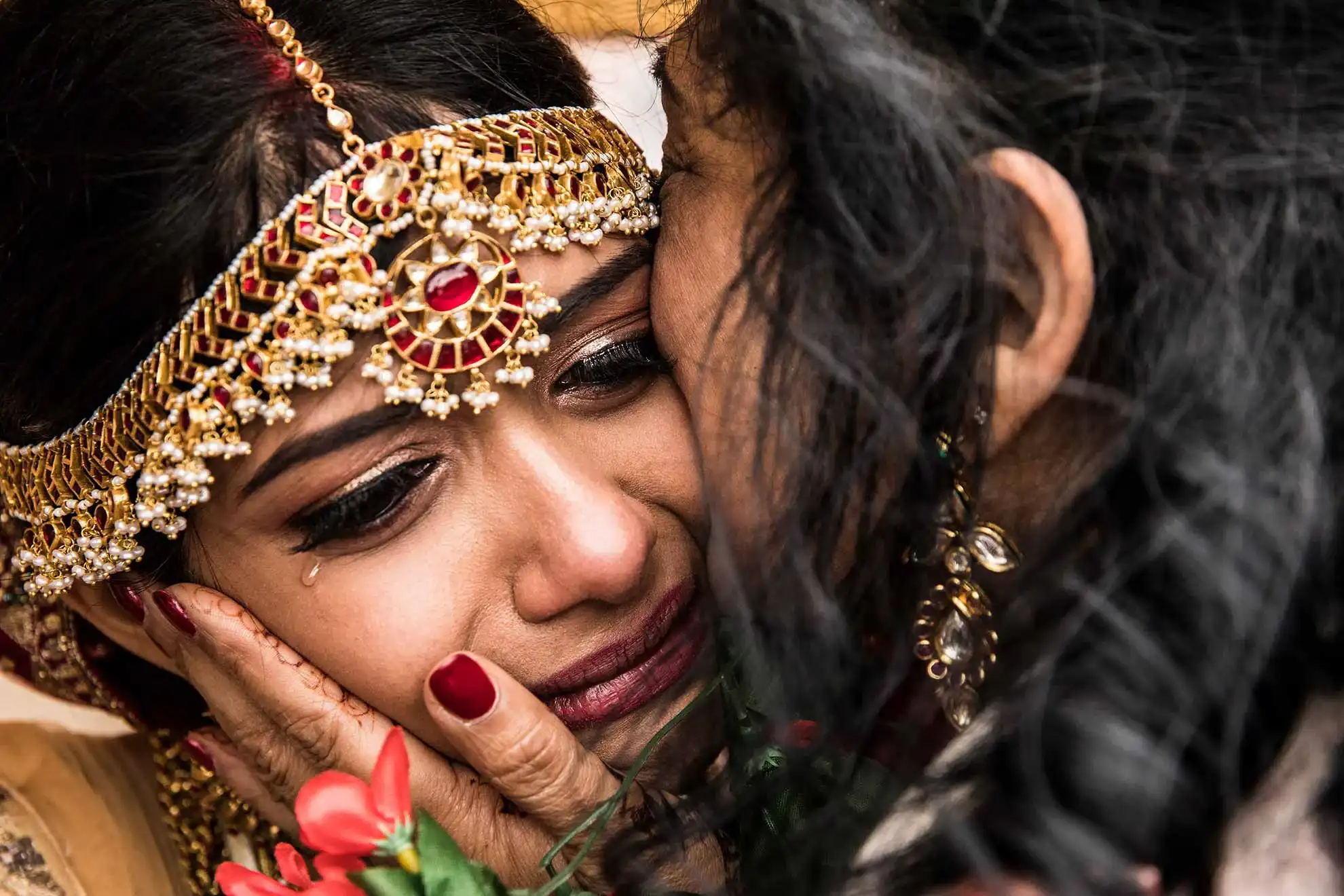Emotional bride in traditional Indian wedding attire during a farewell moment – photographer Mallorca