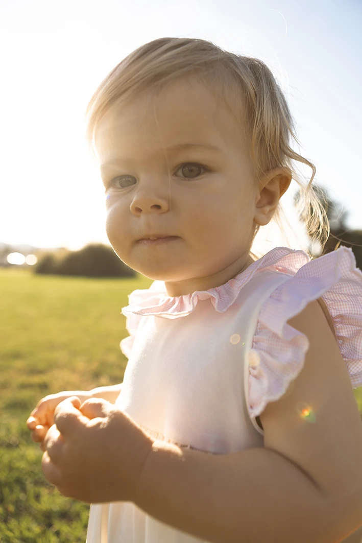 Close-up of a toddler in soft sunlight during a family photo session at Parc de la Mar, Palma de Mallorca.