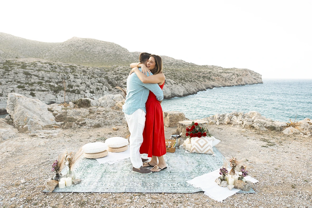 Emotional hug after a sunset surprise wedding proposal in Mallorca