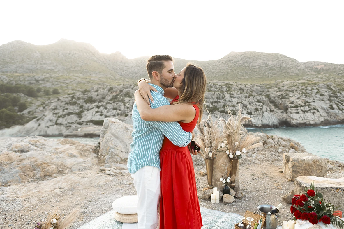 Couple embracing with emotion after a surprise wedding proposal in Mallorca