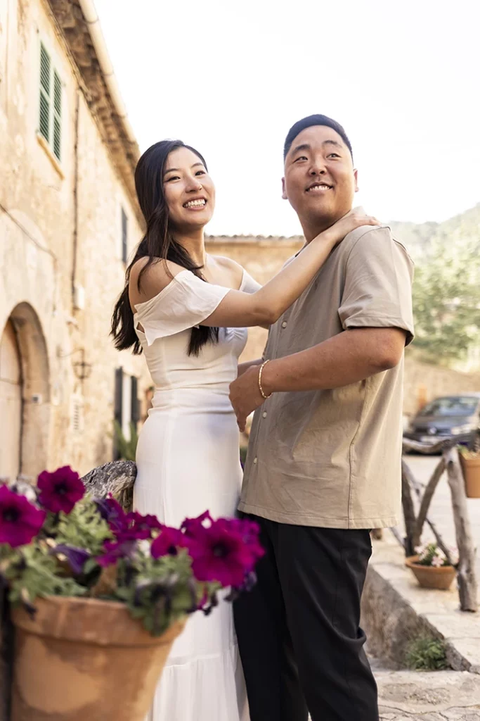Mathew and Emily smile joyfully after their romantic proposal in Mallorca.