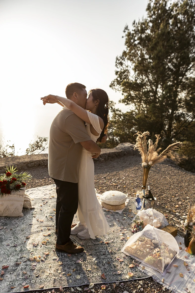 Couple embracing after surprise proposal in Mallorca by Inma del Valle.