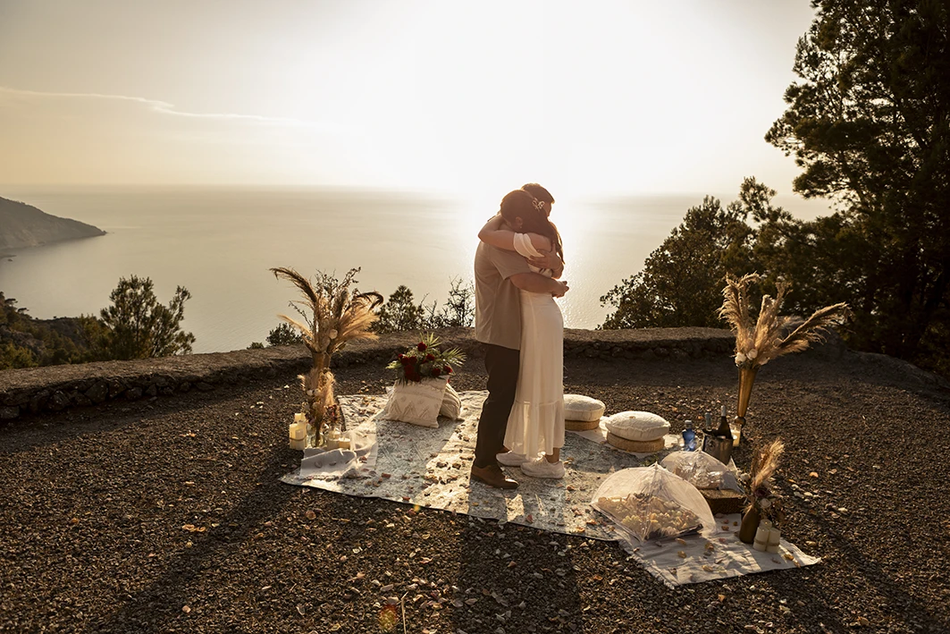 Romantic hug after engagement in Mallorca at sunset.