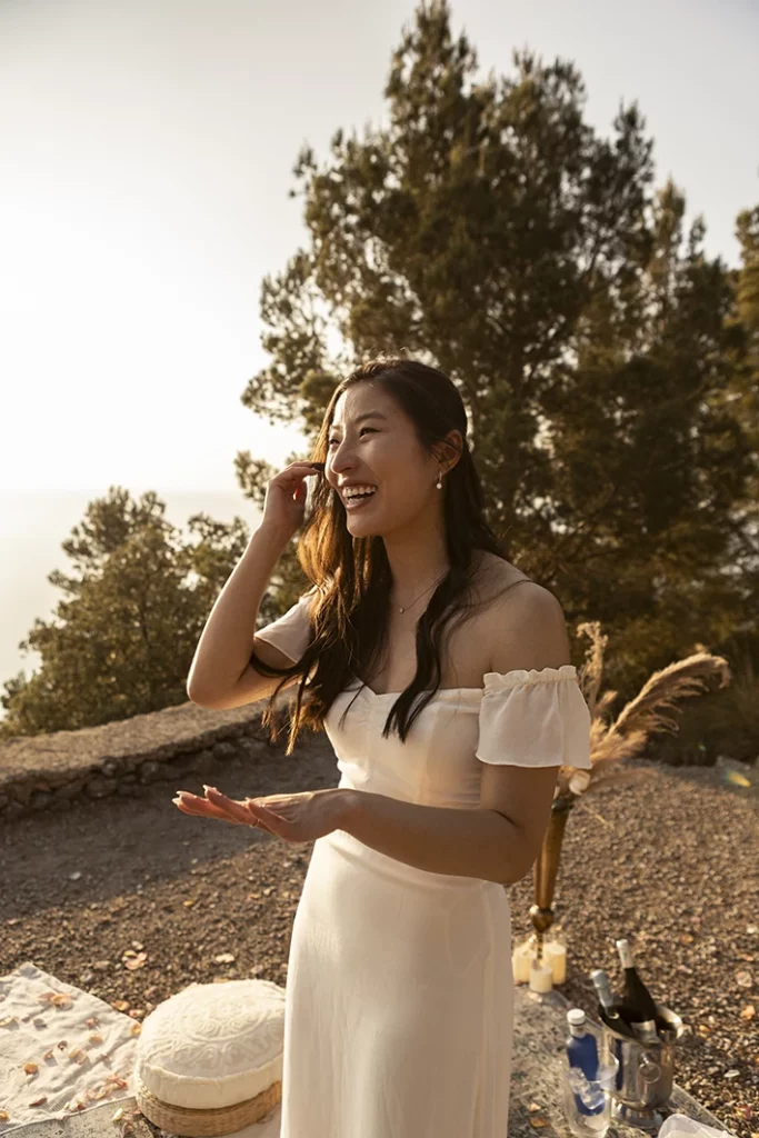 Bride-to-be wiping tears of joy after proposal in Mallorca.