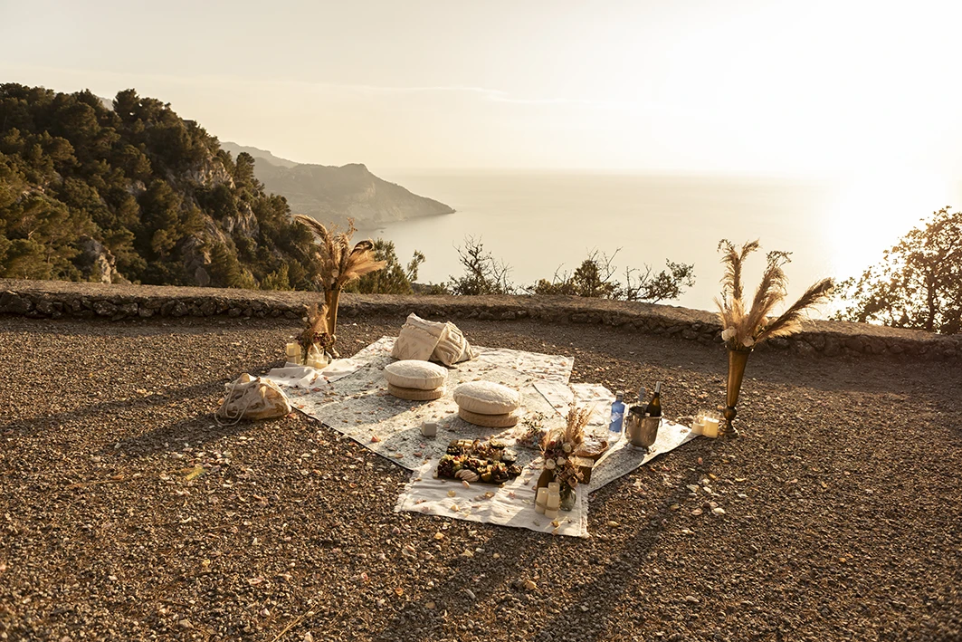 Sunset picnic setup for wedding proposal in Mallorca.