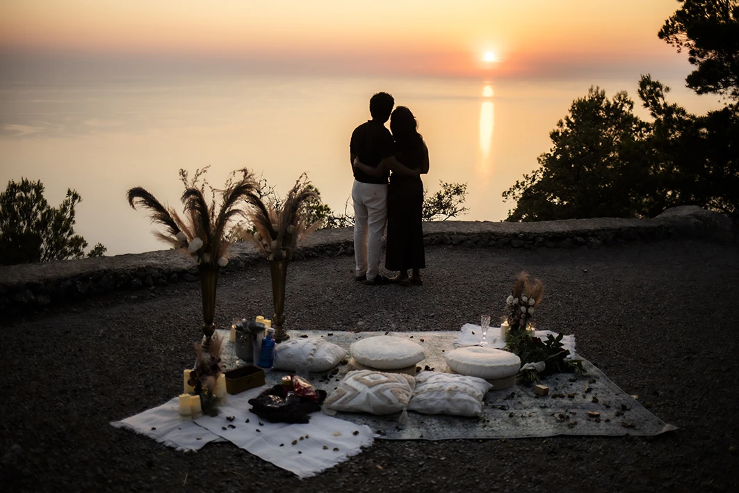 Marriage proposal in Mallorca at sunset with a couple embracing in front of the sea. Organisation and photos by Inma del Valle.