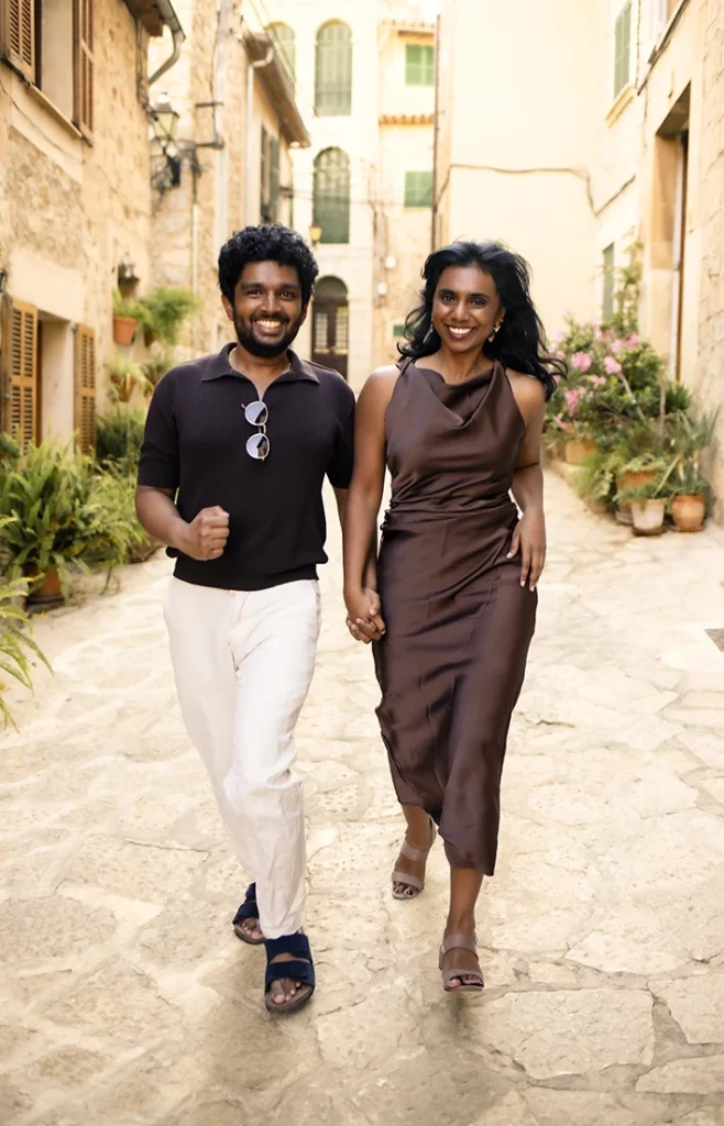 Couple walking happily after their marriage proposal in Mallorca.