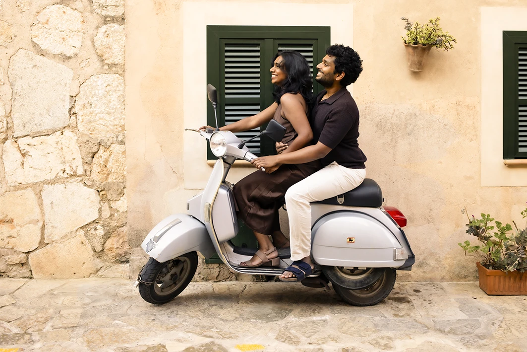 Couple on motorbike after marriage proposal in Mallorca.