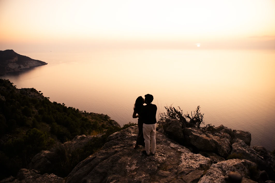 Romantic embrace after marriage proposal in Mallorca at sunset.