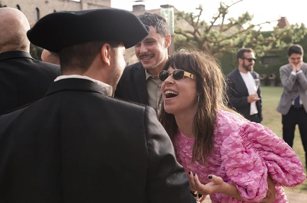 Guest laughing and celebrating with Jon during the wedding at Finca Gordiola.