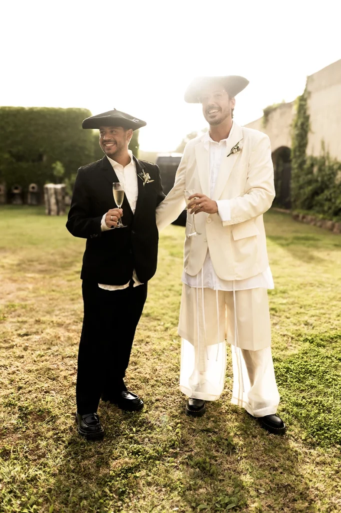 Jon and Santi smiling with sombreros during their wedding celebration at Finca Gordiola.