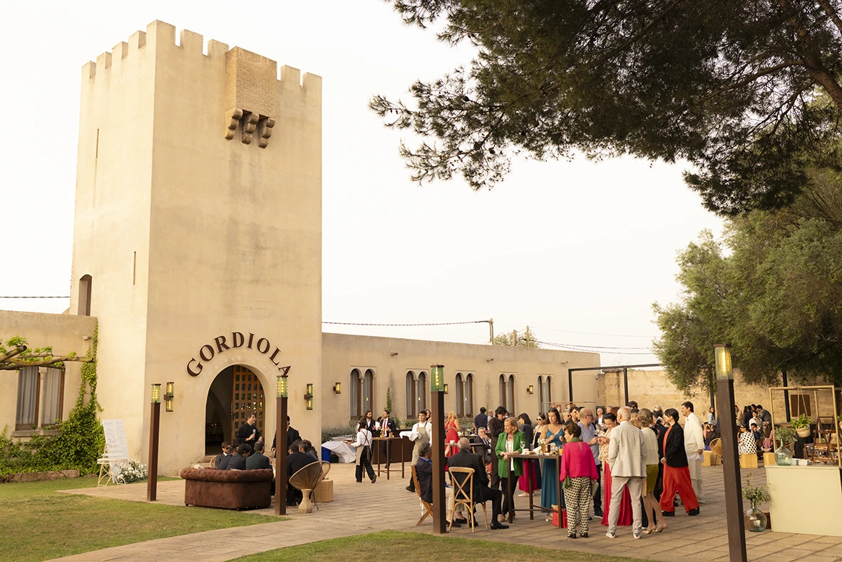 Wedding guests gathering outside Finca Gordiola in Mallorca during cocktail hour.