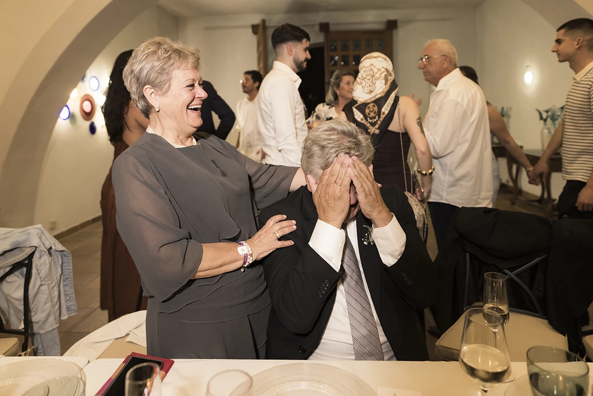 Parents of the groom reacting with joy and emotion during the wedding dinner at Finca Gordiola Mallorca.