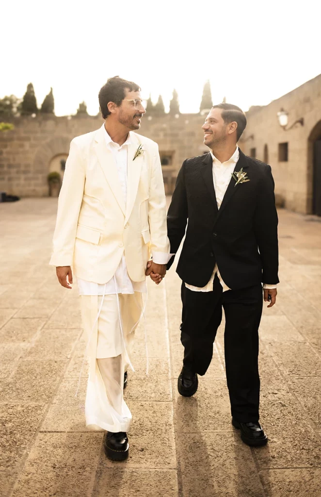 Just married grooms walking hand in hand at Finca Gordiola Mallorca.