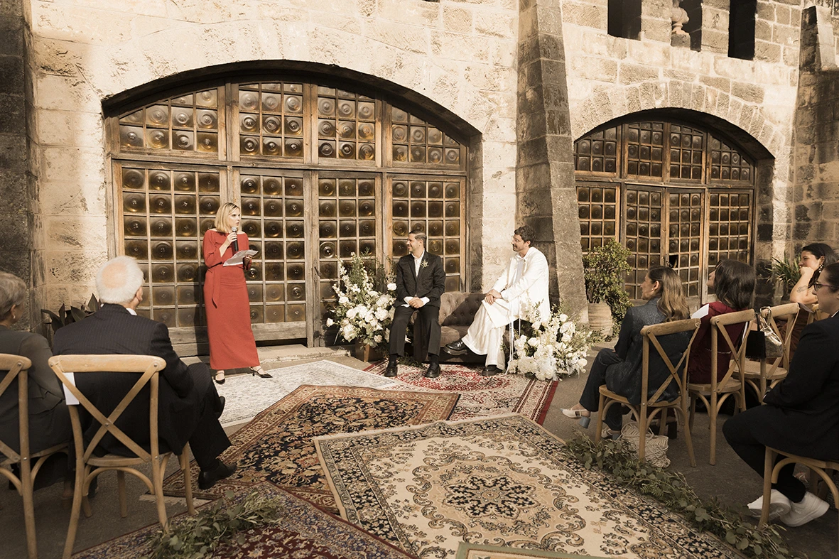 A guest giving a speech to Jon and Santi during their wedding ceremony at Finca Gordiola.