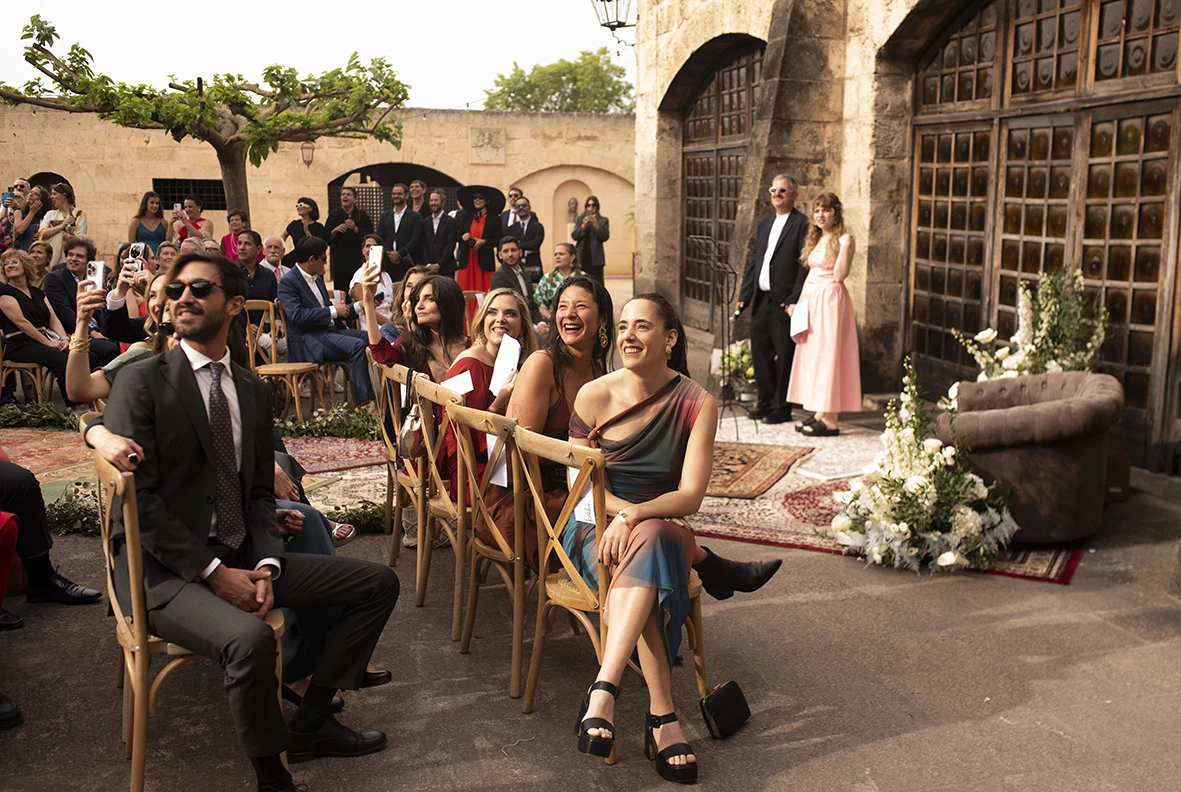 Wedding guests seated and smiling before the ceremony at Finca Gordiola.