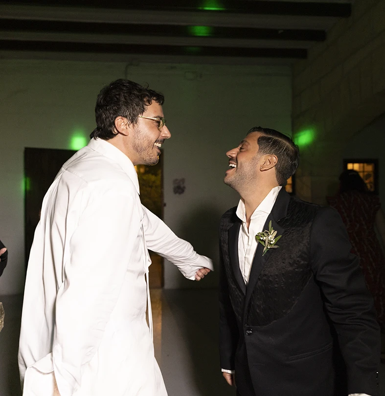 Jon and Santi laughing and dancing during their wedding party at Finca Gordiola.