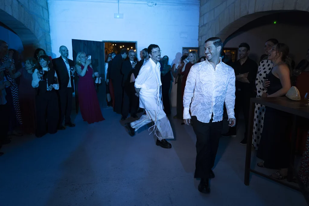 Jon and Santi entering the dance floor during their wedding party at Finca Gordiola.