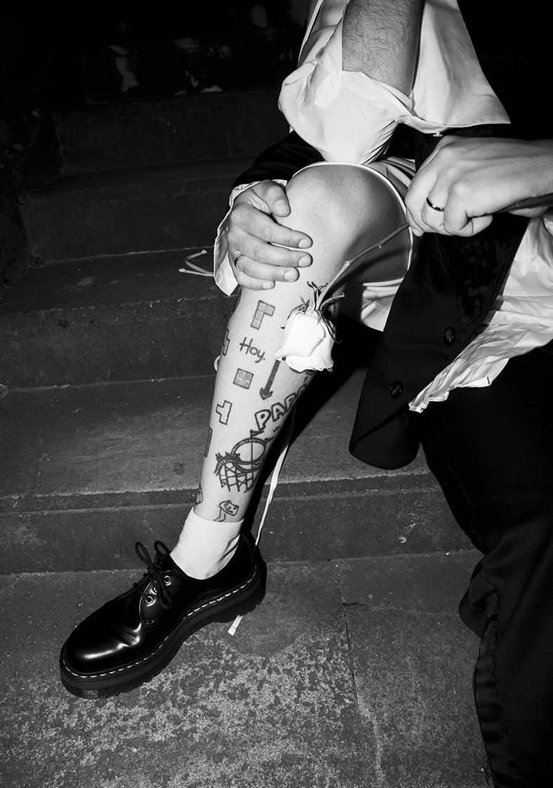 Close-up of Jon’s tattooed leg during his wedding at Finca Gordiola.
