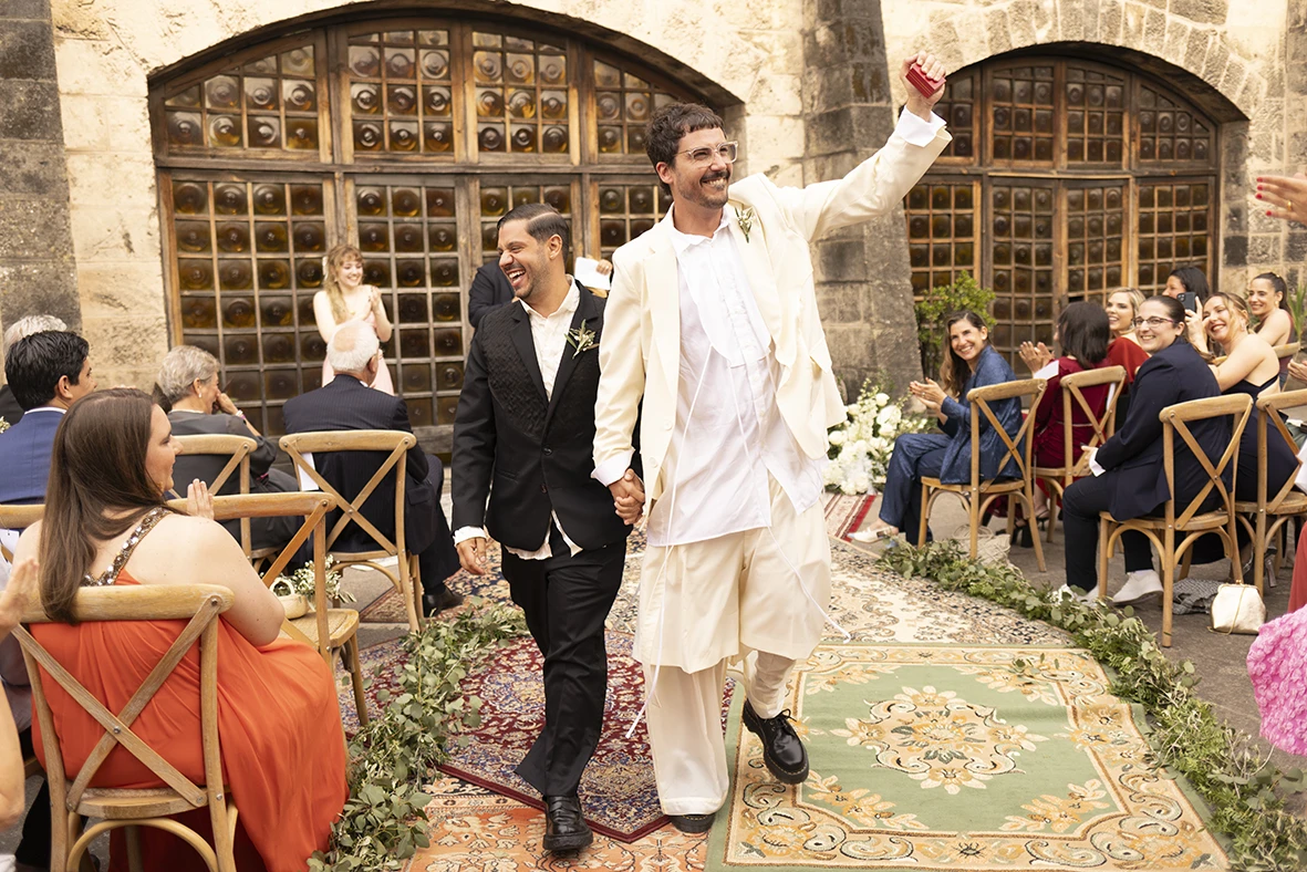 Jon and Santi walking hand in hand after their wedding ceremony at Finca Gordiola.