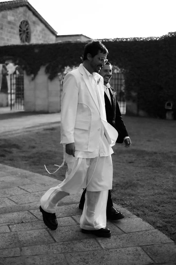 Jon and Santi walking together in a quiet moment at their wedding at Finca Gordiola.