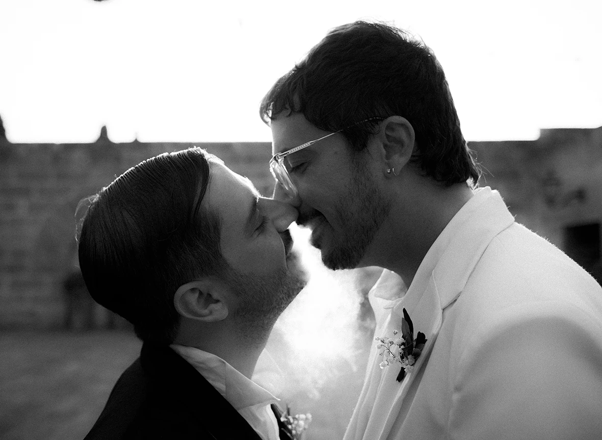 Jon and Santi sharing a kiss at their wedding at Finca Gordiola.
