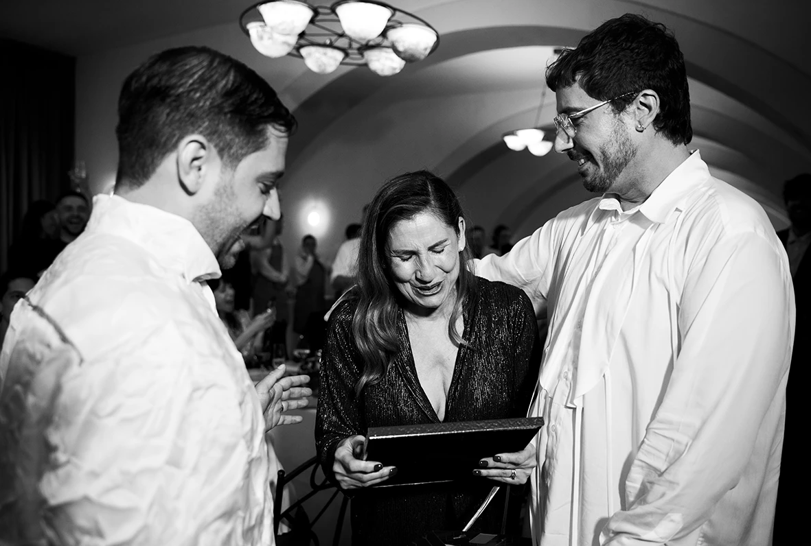 Jon and Santi sharing an emotional moment with a guest during their wedding at Finca Gordiola.