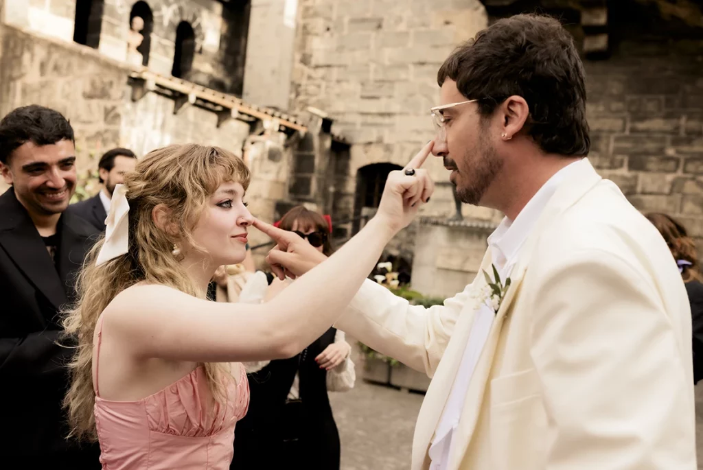 Grooms and guest touching noses at Finca Gordiola Mallorca wedding.