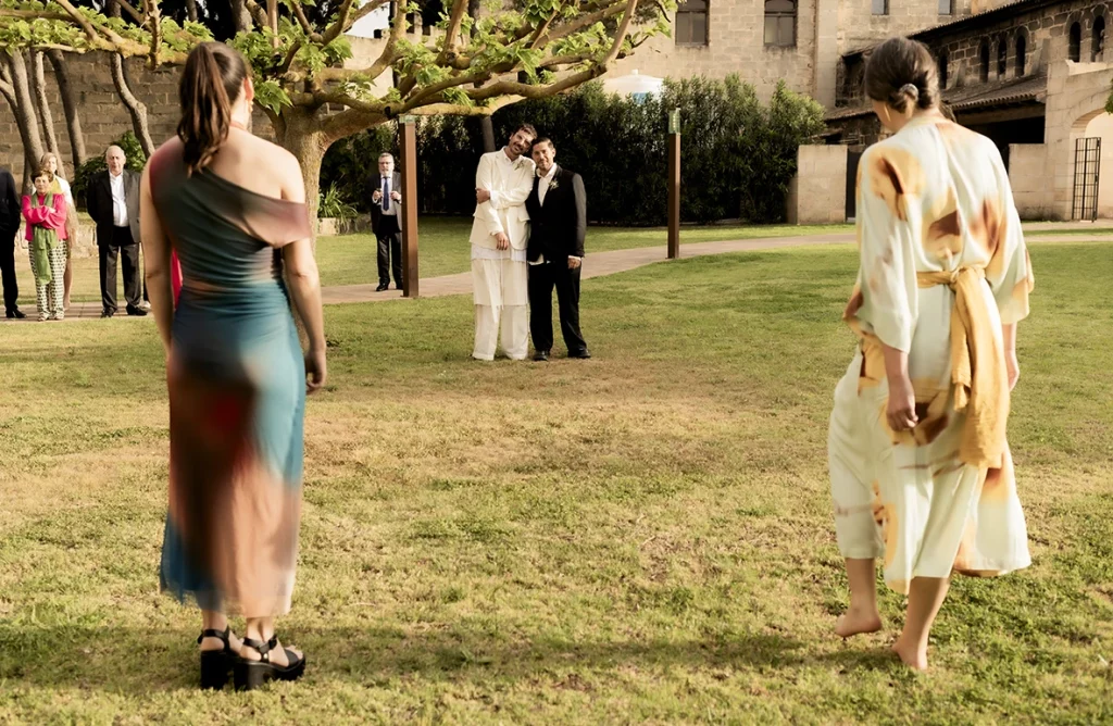 Two grooms kiss in the garden during their wedding at Finca Gordiola Mallorca.