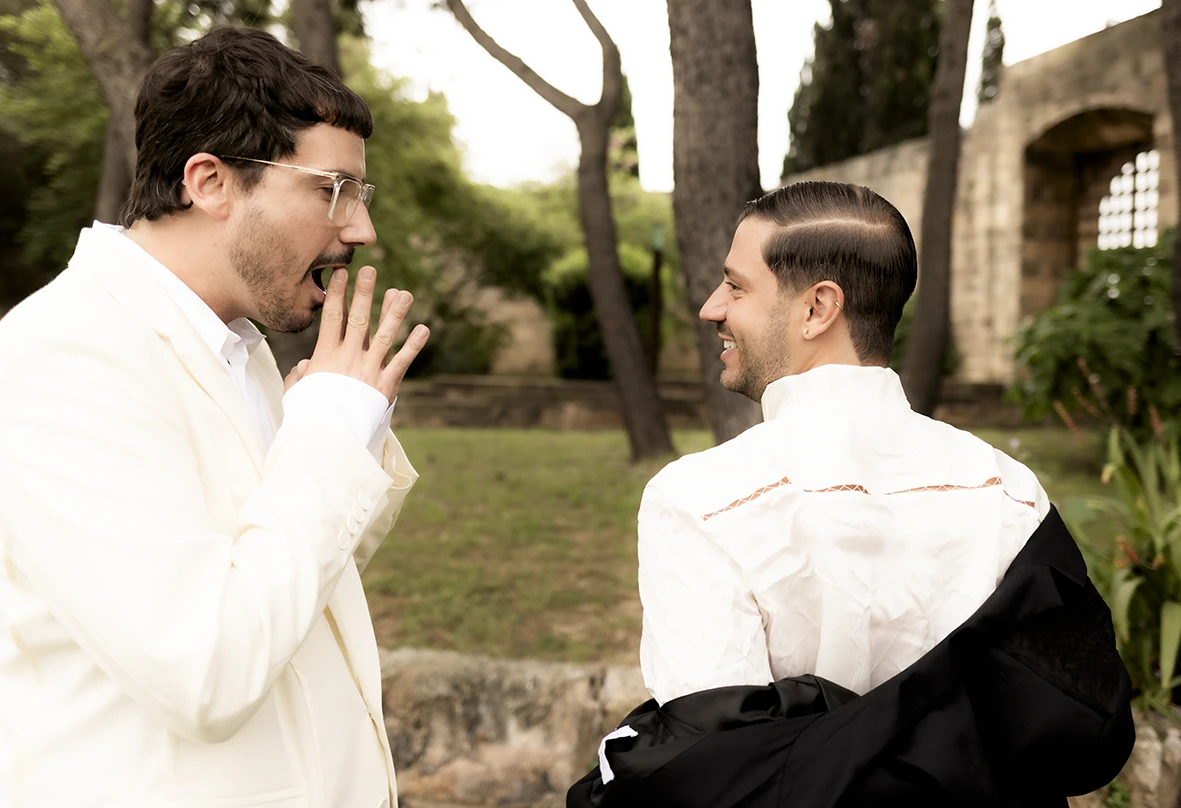 Grooms sharing a joyful moment before the wedding at Finca Gordiola Mallorca.
